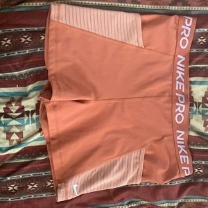 Pink/ coral has zipper in the back 2 pocket Nike pro shorts size large